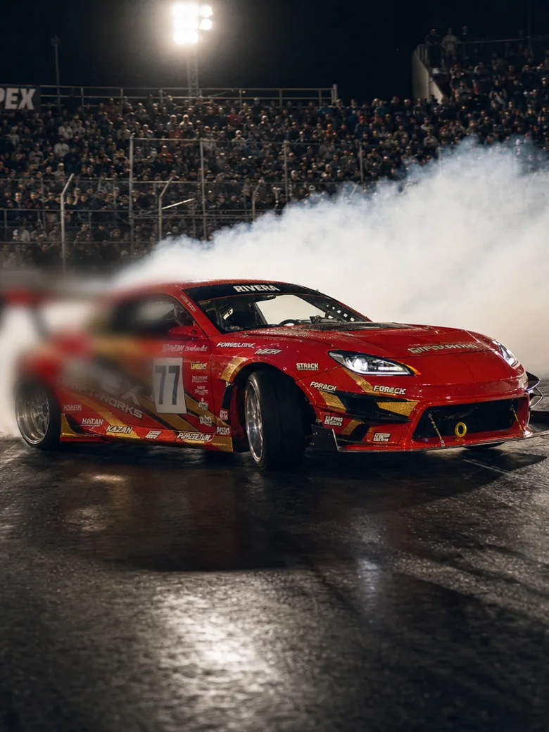 Apex Night Drift: a packed night drift event with cars mid-corner in tyre smoke